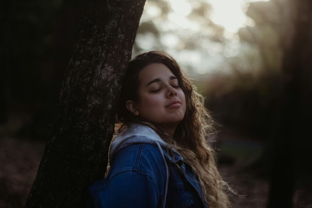Person outdoors in nature, taking time to regulate their nervous system.