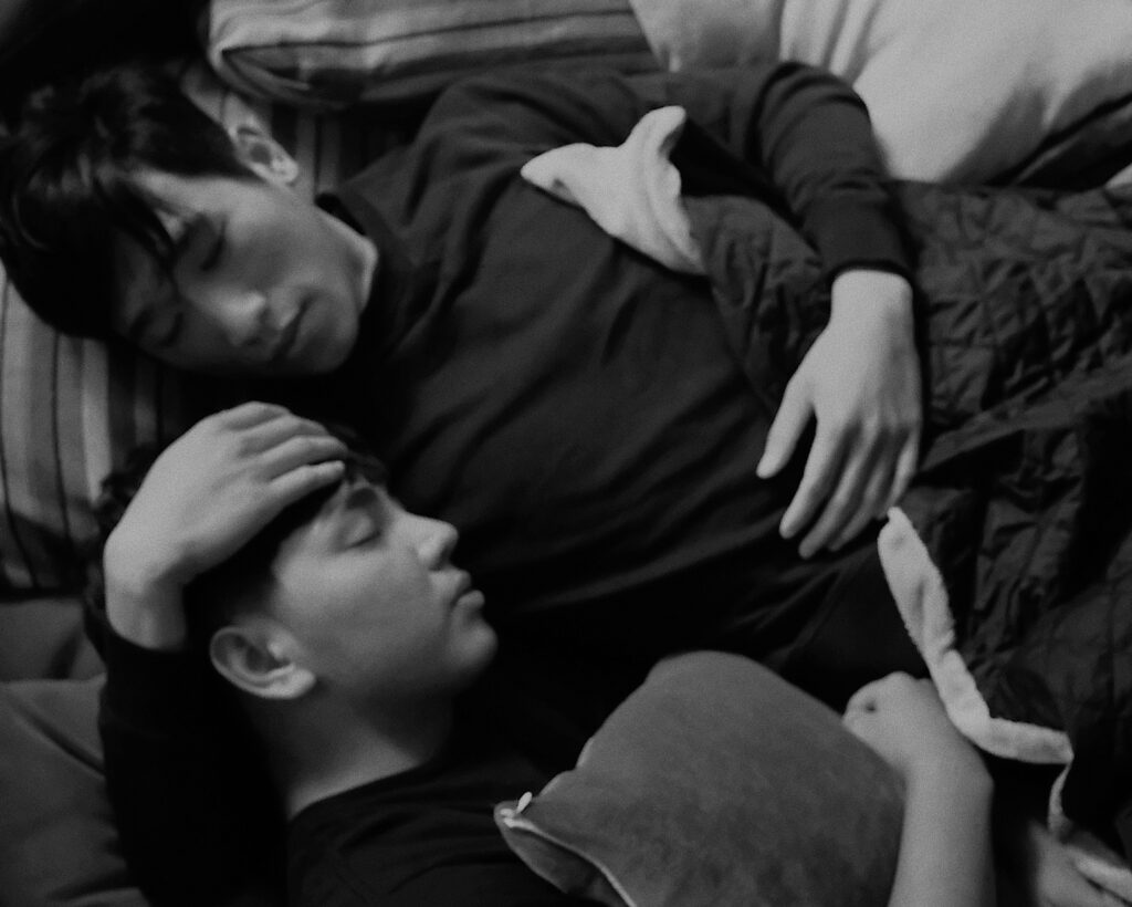 Two people resting together in comfortable closeness, experiencing co-regulation.