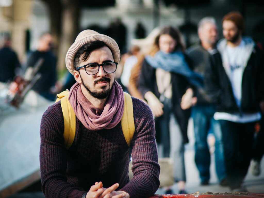 Person sitting alone in a crowd, capturing the isolation of fearful avoidant attachment.