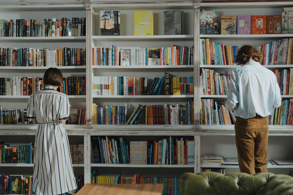 Two people, a man and a woman, shopping in a bookstore.