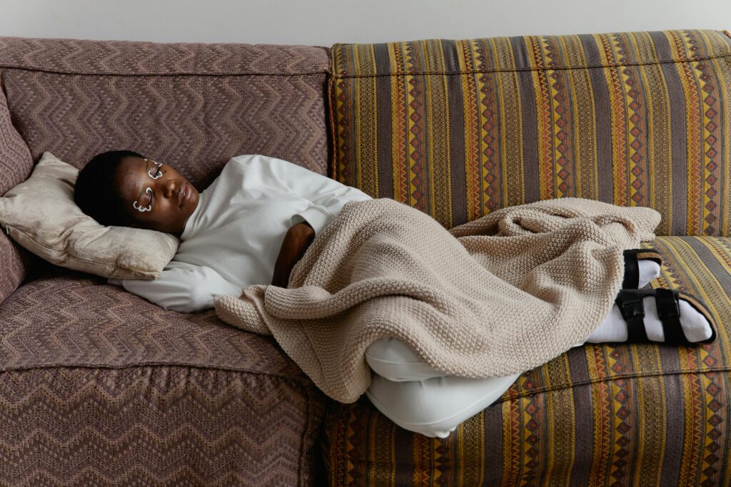 Person wrapped in a weighted blanket, using deep pressure for nervous system regulation.