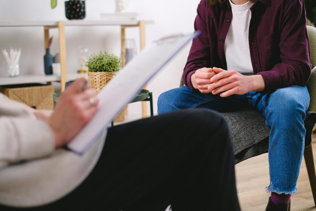 Person in a therapeutic setting, working through the effects of childhood trauma on the nervous system.