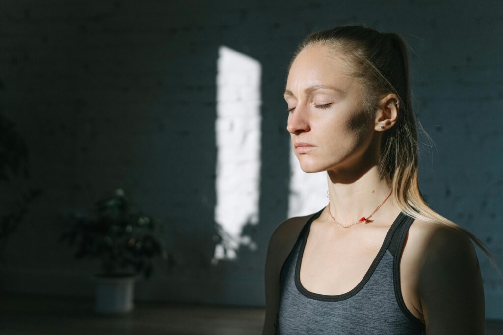 Person sitting in quiet, alert mindfulness practice, representing the nervous system changes that come with consistent meditation.