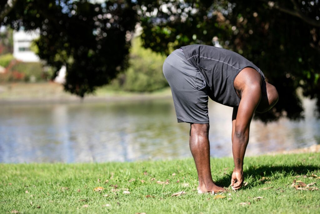 Person doing gentle movement outdoors, supporting nervous system health in the context of chronic pain.