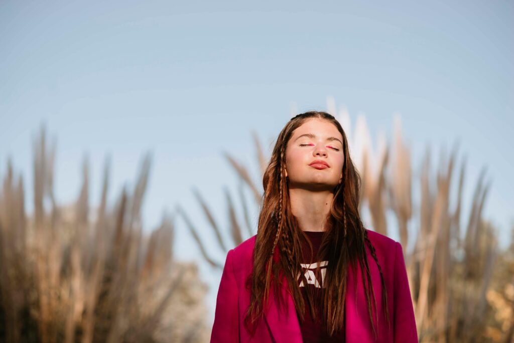 Person sitting alone in quiet reflection, beginning to reconnect with themselves.