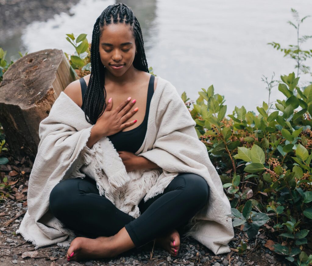 Person with hand on chest, practicing interoceptive awareness and body-based emotional intelligence.