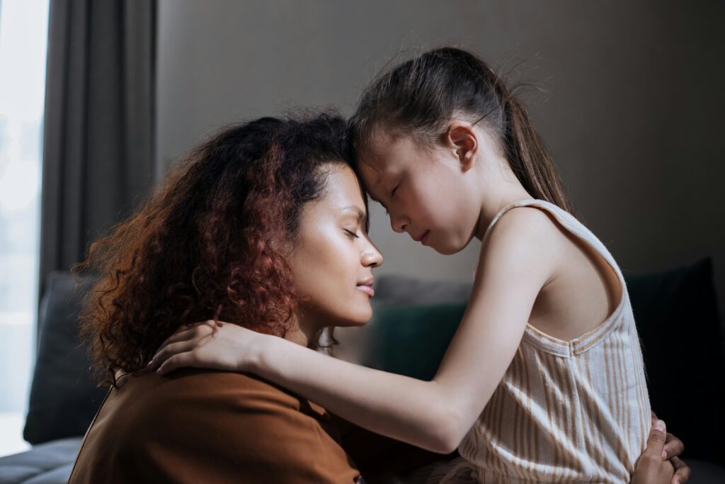 Parent sitting calmly with child, demonstrating nervous system regulation in parenting.