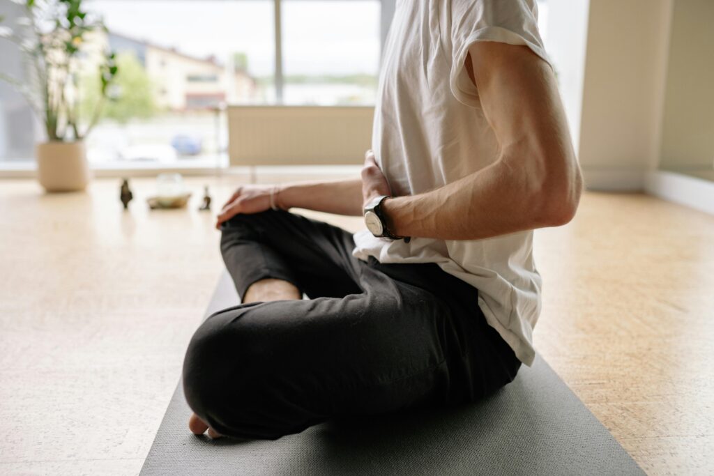 Person sitting with eyes closed practising breathwork for anxiety and nervous system regulation.