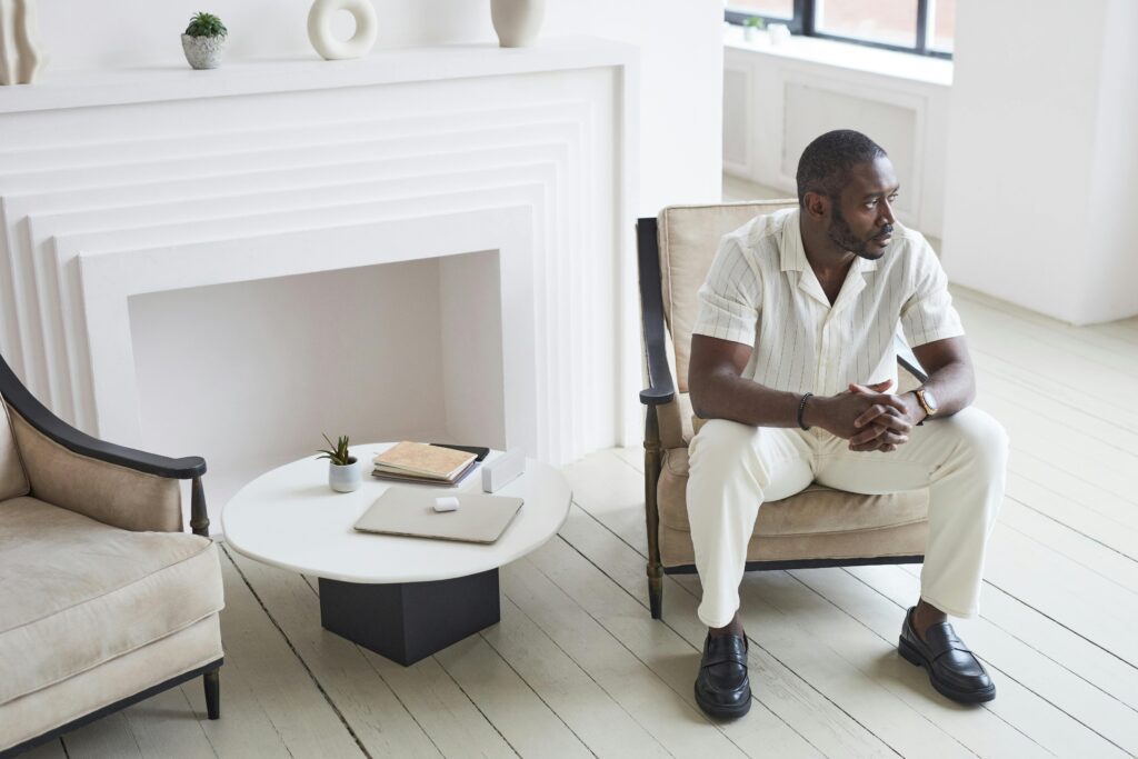 Person sitting in a therapeutic setting, reflecting on the limits and possibilities of healing.
